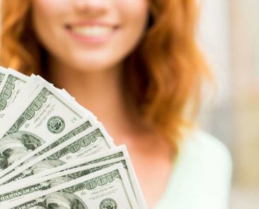 smiling woman and hundred dollar bills